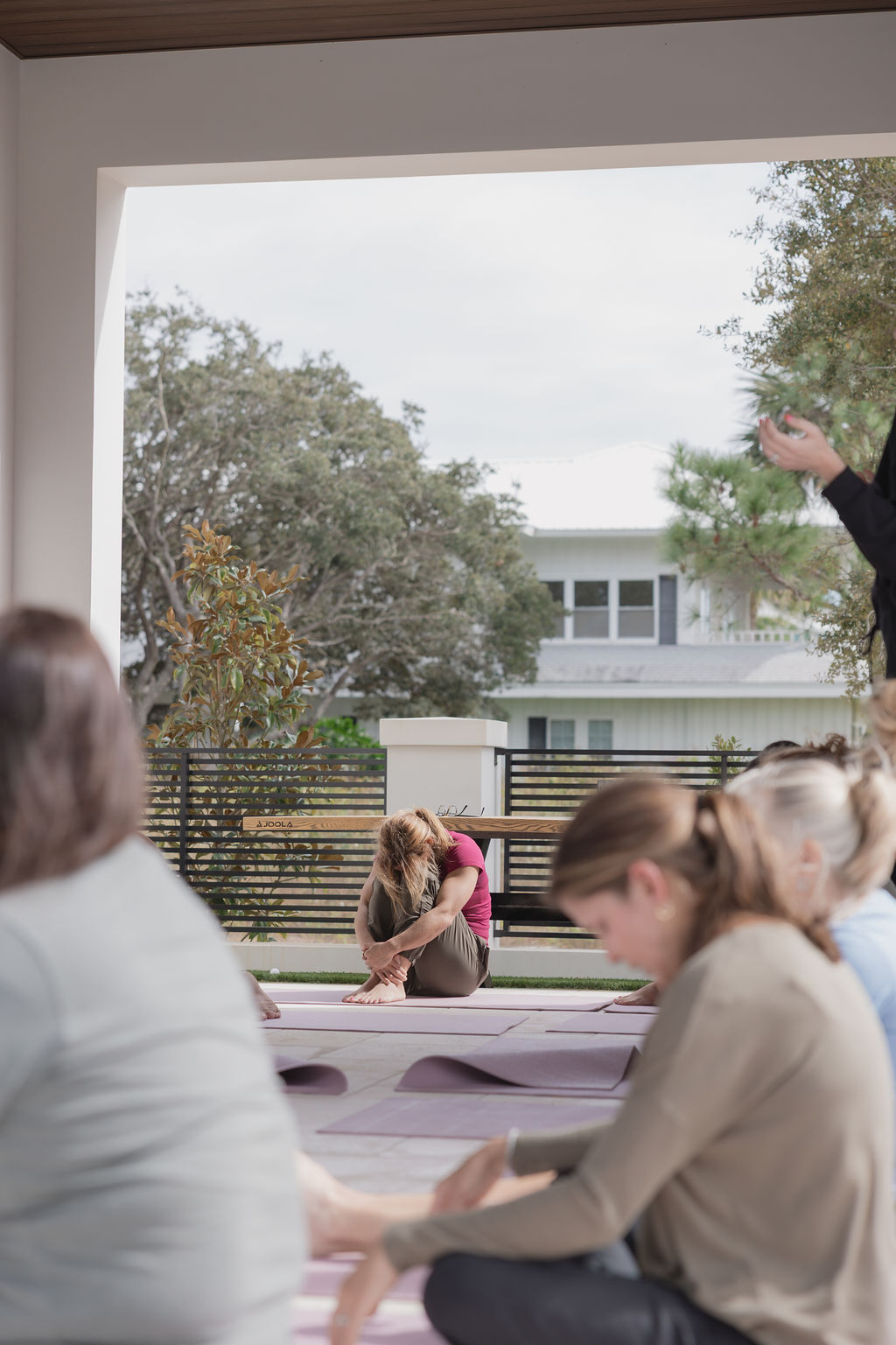 Woman sitting curled forward in reflection during a Kaleo Retreats session