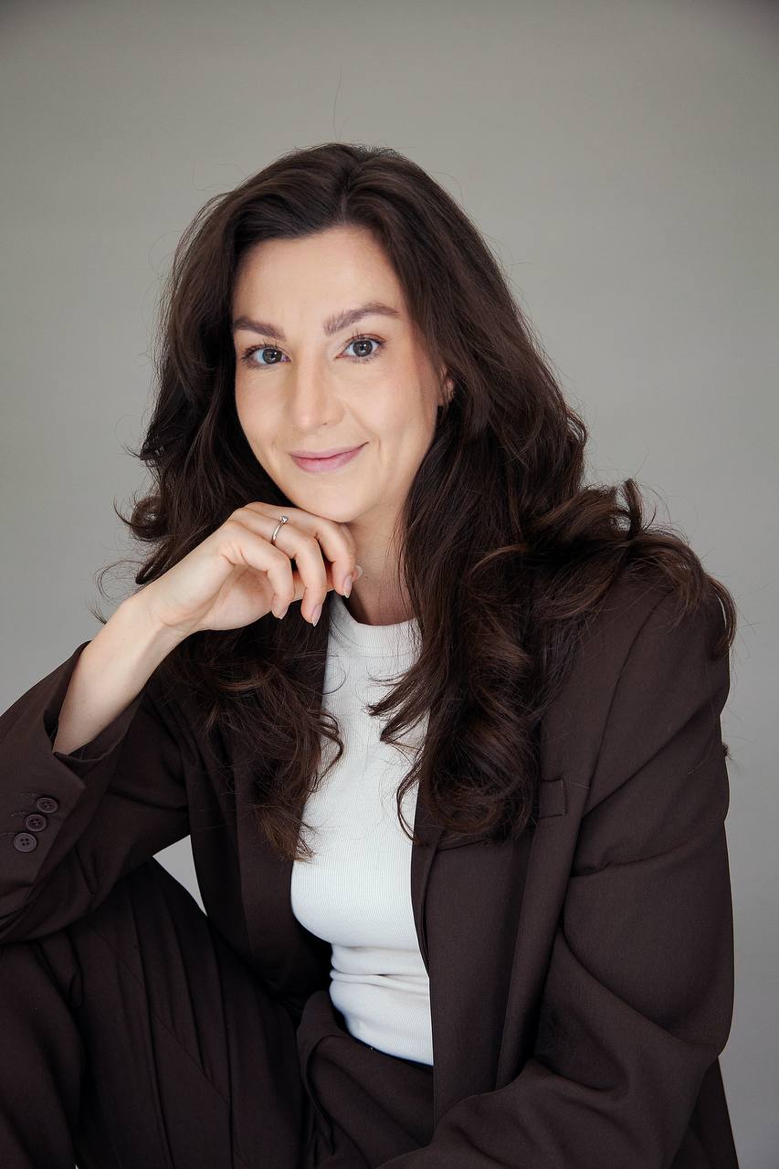 A contemplative portrait, seated on stone steps in evening light